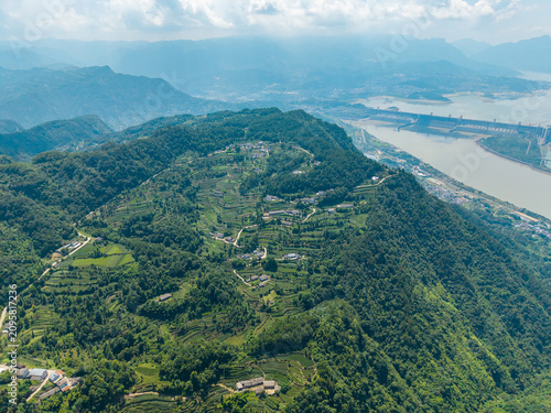 An aerial view shows the lush green mountains and terraced tea plantations located near the Three Gorges Reservoir in Yichang China during a bright summer day