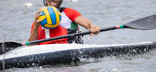 Canvastavla Male athlete in red and white jersey paddling a canoe while holding a yellow and