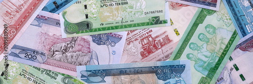 Ethiopian birr money bills pile on table. Ethiopia banknotes of ETB currency close up.
