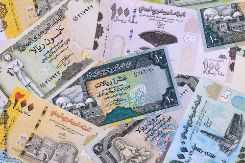 Yemeni rial money bills pile on table. Yemen banknotes of YER currency close up.