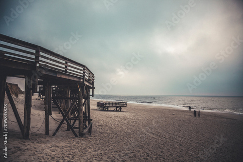 Germany, Sylt, Kampen, Rotes Kliff, wooden steps, beach, walkers, winter