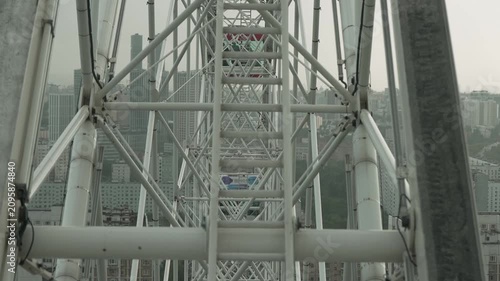 View from the cabin of the Ferris wheel on the Ferris wheel structure and the city
