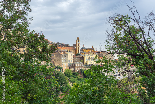 Cervione village church tower rising above hillside town in Corsica