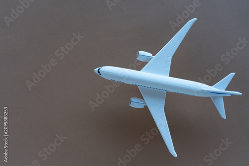 Quadro su tela Image of an airplane against a brown background in landscape format