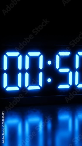 Blue digital timer showing fifty four seconds on black.