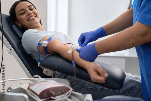 Smiling donor during blood donation procedure in clinic
