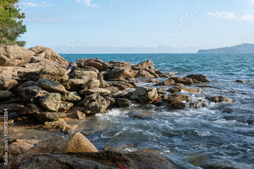 Rocky headlands and rocks are struck by powerful waves that crash with energy. Angra dos Reis – Rio de Janeiro, Brazil.