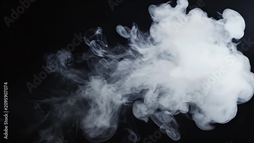 A captivating abstract image showcases swirling white smoke against a stark black background, creating a dynamic and ethereal visual effect.