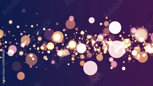 A dreamy abstract image showcases a blurred array of golden and white bokeh lights against a deep purple and blue gradient background, creating a sense of ethereal beauty.