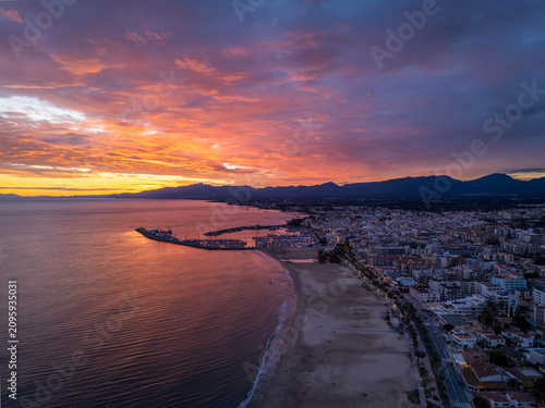 Aerial Sunset Over Coastal City Beach and Marina With Dramatic Sunset, Cambrils, Catalonia, Spain