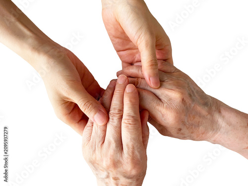 Young hands gently supporting elderly hands on white background