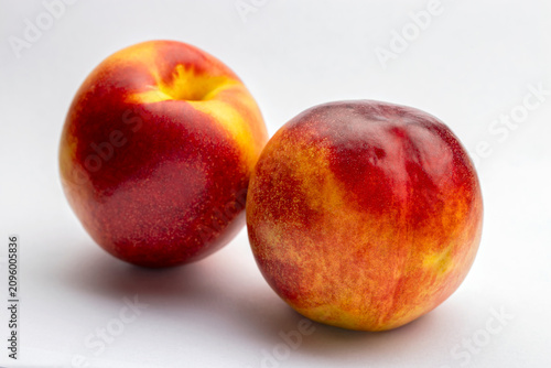 Two ripe nectarines fruit isolated on white background