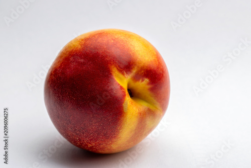 A ripe nectarine fruit isolated on white background
