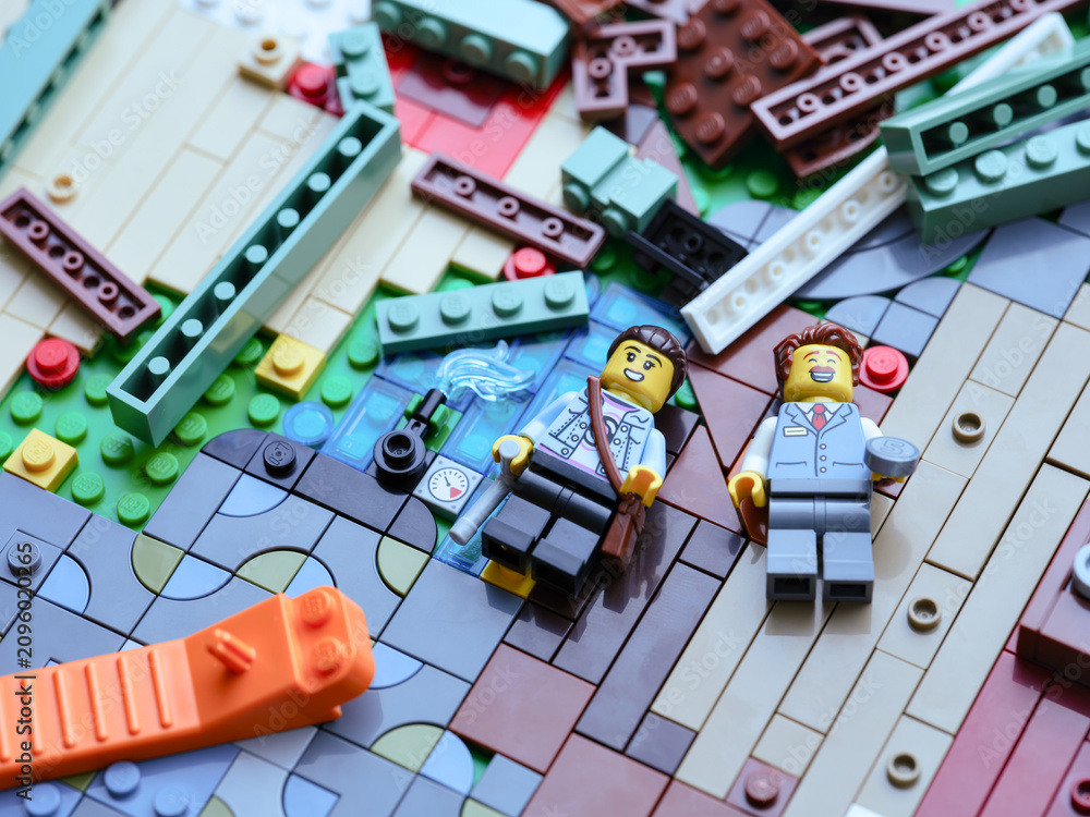 Fototapeta premium Tambov, Russian Federation - June 22, 2026 A pile of Lego pieces with a brick separator and minifigures. Close up.