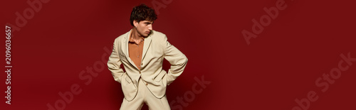 Handsome young man showcases style and elegance in a chic setting with striking background