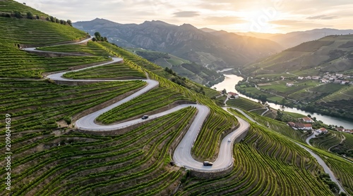 Winding road through terraced vineyards with a river valley and distant mountains scenic view country
