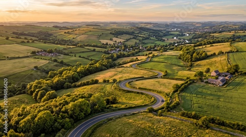 Winding country road through green rolling hills at sunset scenic landscape photography rural asphalt pavement