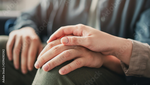 Young couple holding hands and supporting each other