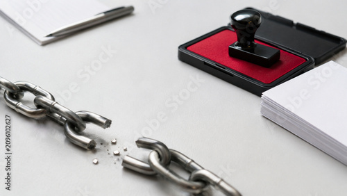 Broken chain on office desk symbolizing stopping corruption