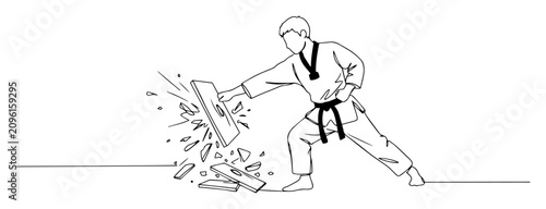 Photography karateka breaking board with powerful strike