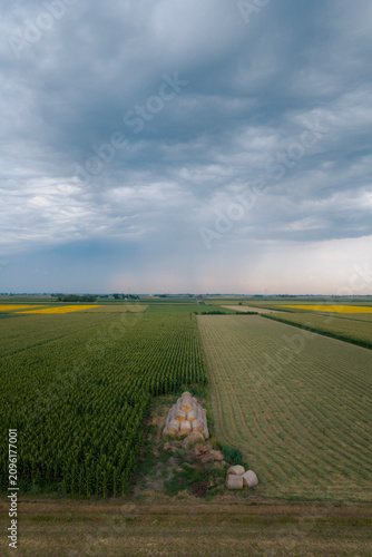 A massive, powerful summer storm looms over vast fields