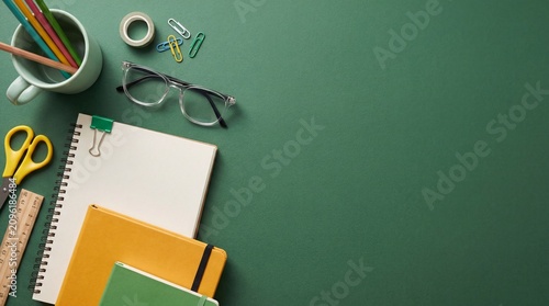 Green background with office supplies and school stationery
