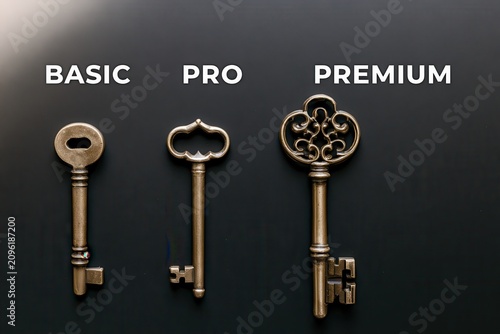 Three vintage keys in a row. Metaphor for service tiers.