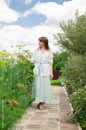 Woman exploring vegetable garden in casual outfit on sunny day  