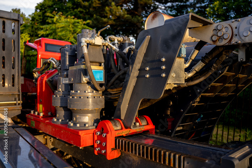 Hydraulic drive motors with planetary gearboxes mounted on a heavy directional drilling rig rack system, industrial fluid power machinery and trenchless engineering details.
