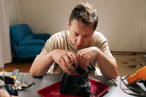 Fotografie Focused technician performing computer hardware maintenance, installing cpu cooling system, ensuring optimal performance for modern gaming or workstation setups and repairing