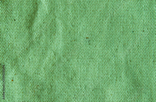 Close up light Mint Pistachio green cotton linen canvas texture with woven details. Natural coarse texture for design fabric background. Rough crumpled hessian burlap background.