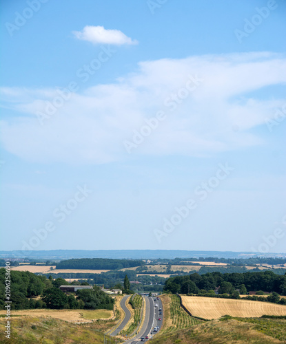 The Rolling Hills and dramatic road compression of Colliery Way (Gedling Access Road) seen from Gedling Country Park, sky-dominant vertical composition