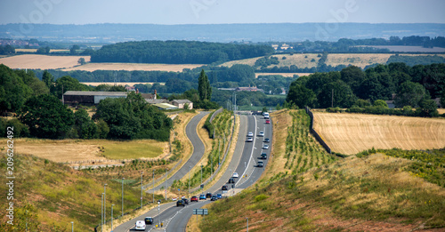 The Rolling Hills and dramatic road compression of Colliery Way (Gedling Access Road) seen from Gedling Country Park, Wide landscape composition