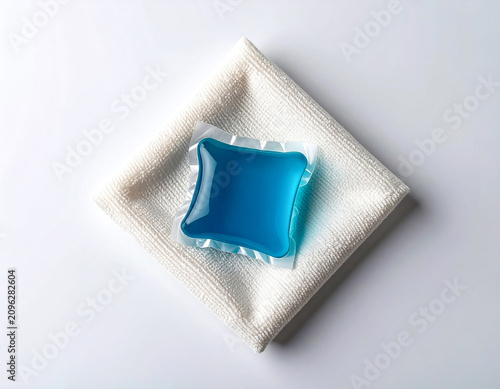 Gel laundry capsule. Soluble laundry detergent capsule on a neutral linen cloth with empty space for text.