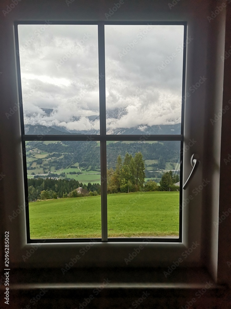Obraz premium Scenic mountain view through a window with natural light