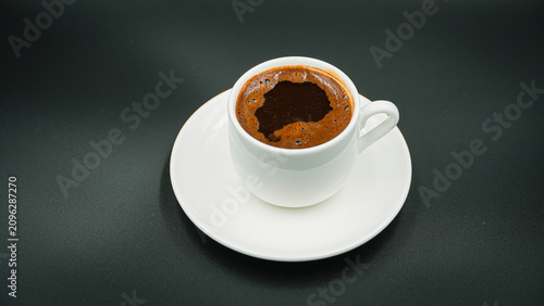 White Cup of Hot Turkish Coffee Isolated on a Black Background