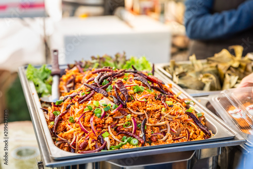 Obraz na plátně Spicy Thai rice salad with dried chilies and fresh herbs served at a street food