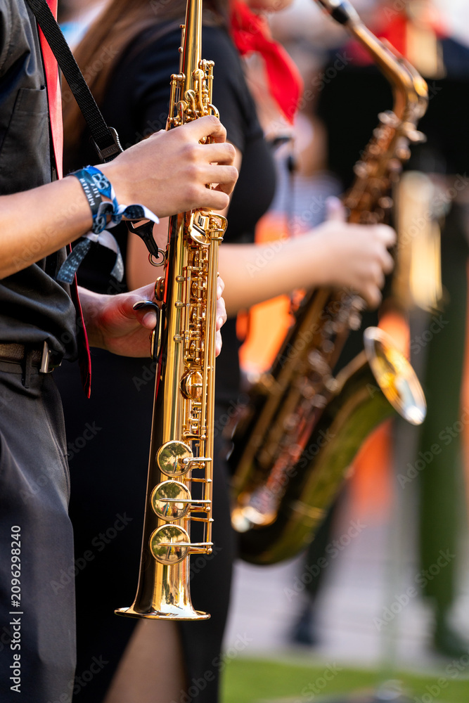 Obraz premium Young musician performing on a saxophone during a vibrant street concert in spain