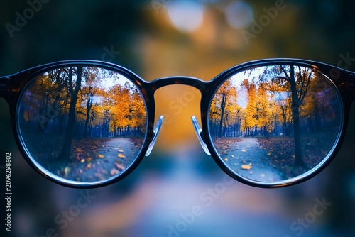 Glasses reveal a vibrant world with bustling streets and autumn foliage