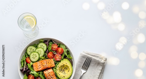 Healthy salmon salad bowl. Fresh keto meal with avocado.