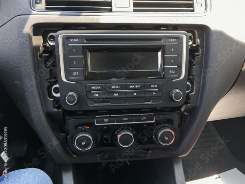 Car radio mounted in the center dashboard console of a vehicle.