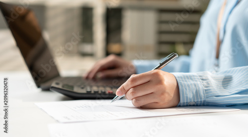 Foto Businesswoman under check accountant for working on tax and finance, budget planning, payment processing, financial reporting and business accounting management concept