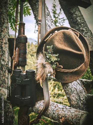 still life of hunting equipment on a high seat in the mountains