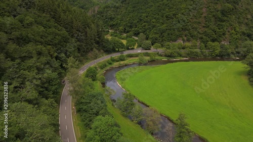Cars Driving on Valley Road Alongside Sauer River