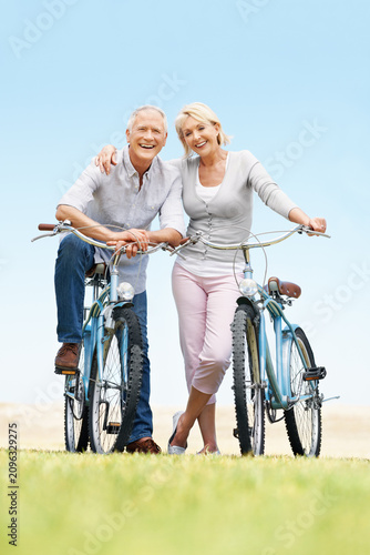 Obraz na plátne Love, portrait or elderly couple in park with bicycle, bonding or happy moment in weekend activity