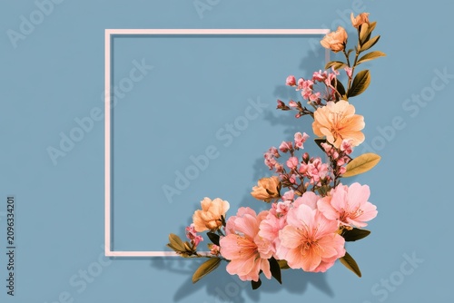 Delicate Pink Peach Blossoms Branch In Thin White Frame On Soft Blue Background flowers petals