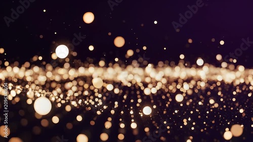 Golden light particles bokeh abstract background for festive holiday celebration