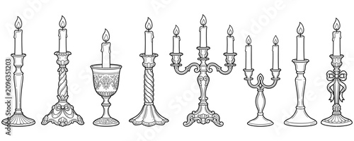 Slika na platnu Set of elegant antique candle holders with lit candles and ornate details