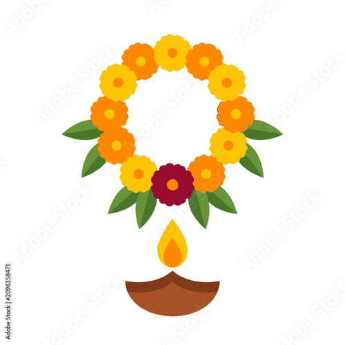 A traditional Diya lamp glows beneath a festive marigold flower garland