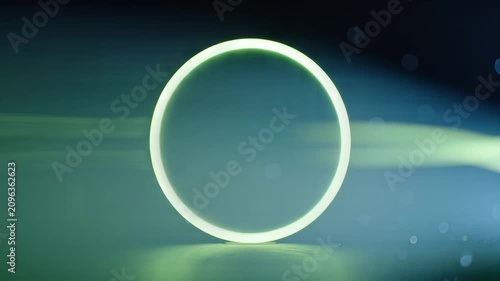 Green plant stalk inside glowing glass ring with sparkling bokeh effect on dark background